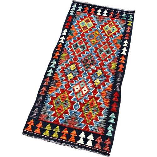 1752 - A Chobi Kilim runner with interlocking stepped lozenges 143cm x 67cm approximately