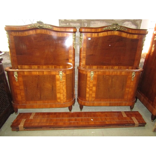 1340 - A pair of continental single bedsteads with rosewood veneer and satin wood cross banding and cast me... 