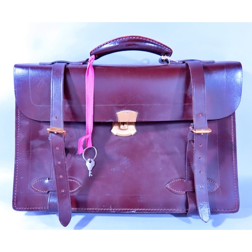 629 - A lockable leather satchel, with three divisions complete with key.