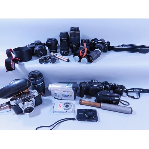 633 - A quantity of early digital cameras, video recorders, lenses, an old Halifax camera, a pair of binoc... 