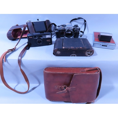 635 - A Kershaw 450 folding camera made in England, with it’s leather case, an Olympus OM 20 camera, a sel... 