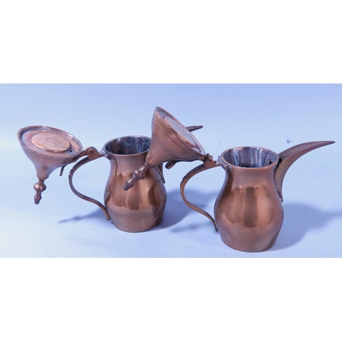 640B - A small Iranian metal tray with a pierced rim and two small Arabic coffee pots.