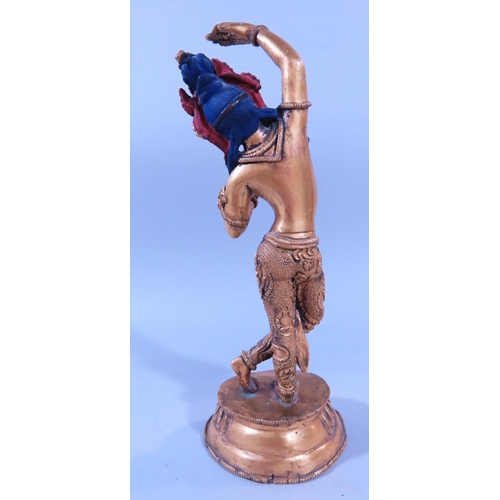 641A - A gilded bronze Indian dancing female figure, on a lotus base 21cm tall