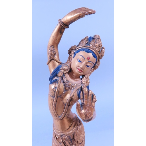 641A - A gilded bronze Indian dancing female figure, on a lotus base 21cm tall