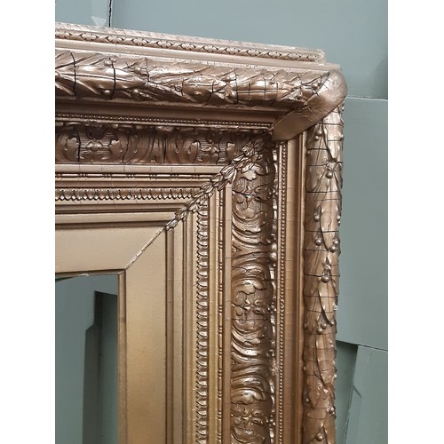 1987 - A large 19th century gilt gesso picture frame with moulded laurel leaf decoration, interior dimensio... 