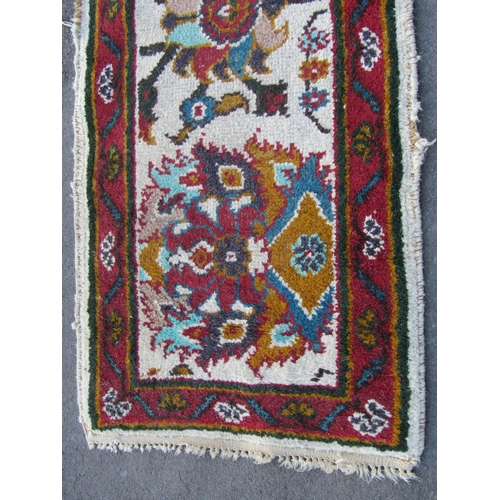 1754A - Indian wool runner, cream ground with floral detail within a running border, 370cm x 70