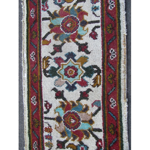 1754A - Indian wool runner, cream ground with floral detail within a running border, 370cm x 70