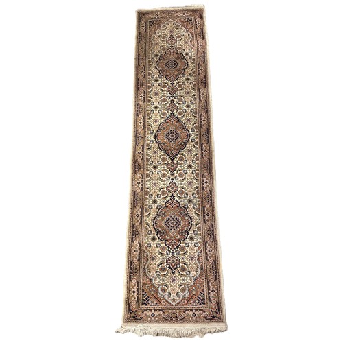 1738 - A Persian style runner  with three  circular medallions on a floral cream ground 76 x 320cm approxim... 