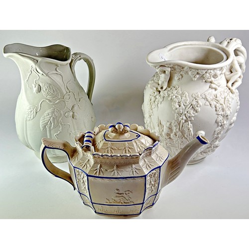 35 - An early 19th century Castleford teapot with blue line banding, together with two smear glazed jugs