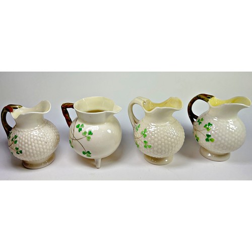 62 - A collection Belleek porcelain to include six small assorted jugs to include a shell moulded example... 