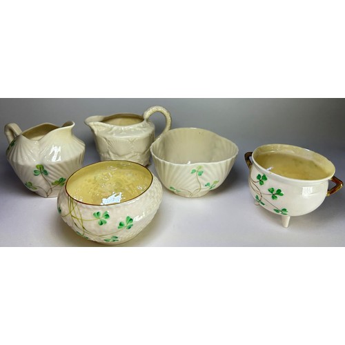 62 - A collection Belleek porcelain to include six small assorted jugs to include a shell moulded example... 