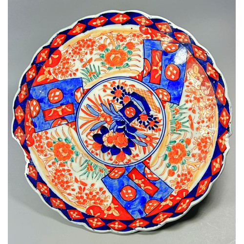 95 - An early 19th century Derby plate with floral detail, two Imari dishes and one other