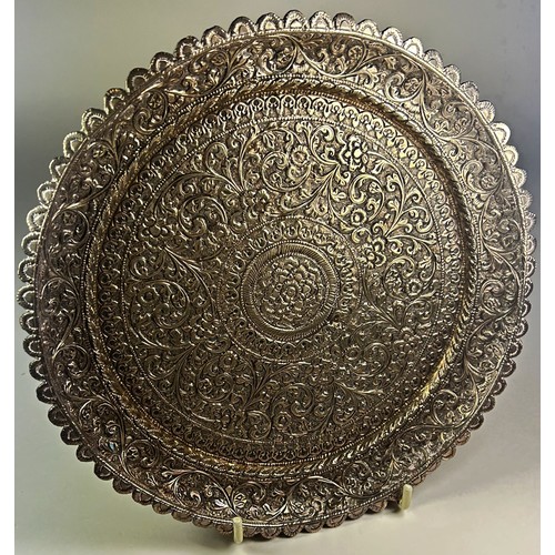 233 - A middle Eastern silver metal floral engraved plate and similar small vase, (af) 20cm D, 14cm H (2)