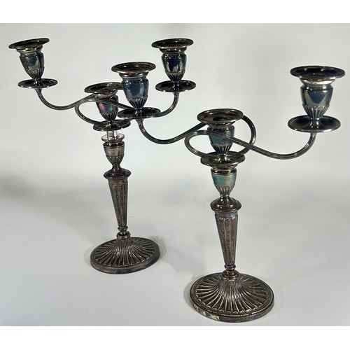 254 - A pair of silver plated Regency style candelabra with a central sconce flanked by two scrolled branc... 