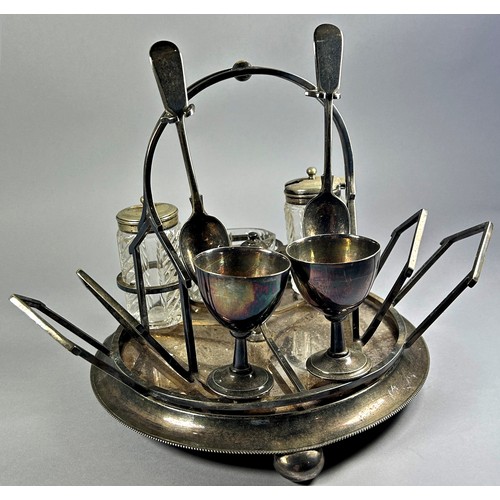 256 - A silver plated “LETTER” rack, a silver plated revolving breakfast set with egg cups, toast rack and... 