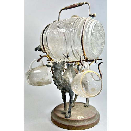 261 - A glass wine barrel in a wire work frame supported by a silver plated camel, 23cm high.