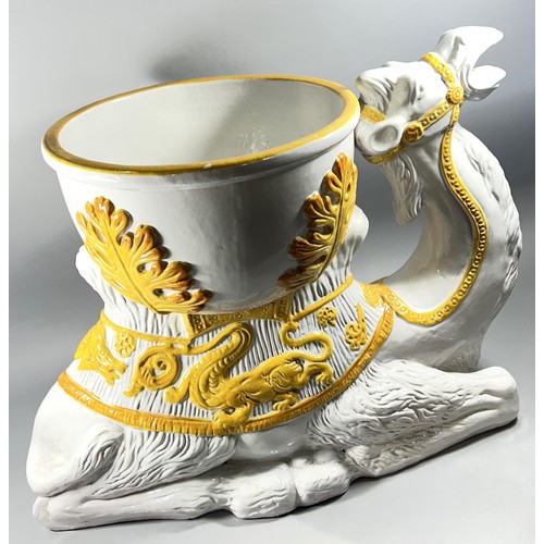 75 - A substantial ceramic jardiniere in the form of a recumbent camel, white glaze with yellow highlight... 