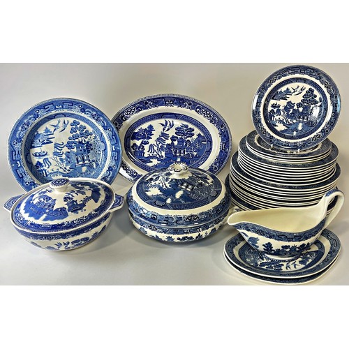 21 - A collection of Wedgwood and Alfred Meakin Willow pattern tableware comprising graduated plates, tur... 