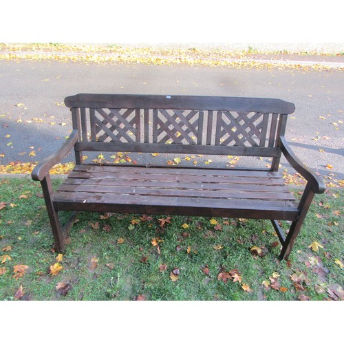 1020 - A stained teak garden bench with slatted seat and lattice panelled back (complete with loose seat cu... 