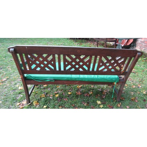 1020 - A stained teak garden bench with slatted seat and lattice panelled back (complete with loose seat cu... 