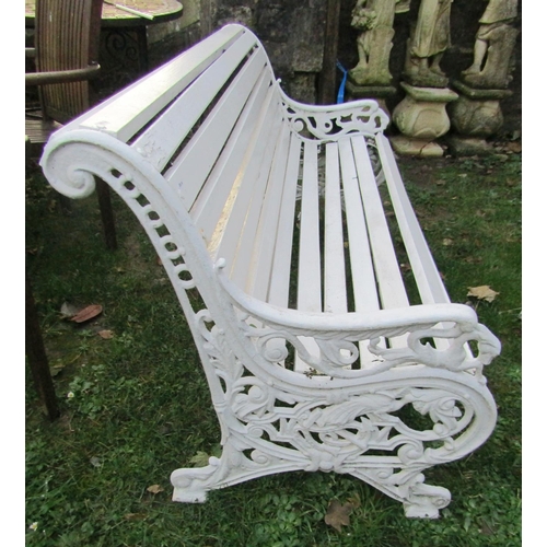 1023 - A 19th century garden bench with painted wooden slatted seat and combined back raised on decorative ... 