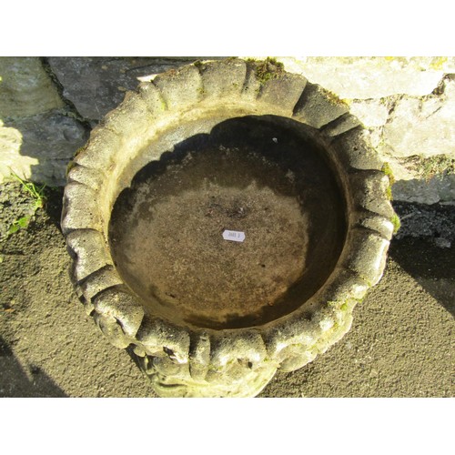 1011 - A weathered cast composition stone bird bath of circular form with acanthus bowl and cherub support ... 