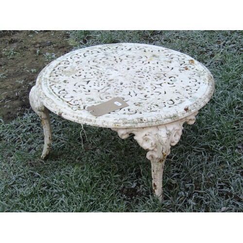 1004 - A  low circular cast iron garden table with decorative pierced top raised on three swept supports wi... 