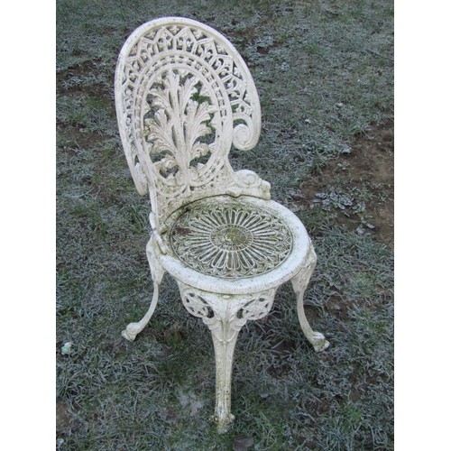 1007 - A cream painted cast aluminium garden terrace table of circular form with decorative pierced top rai... 