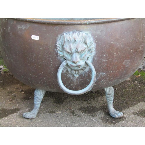 1035 - A large weathered/patinated copper circular pan/cauldron with loop handles and later lions mask fitt... 