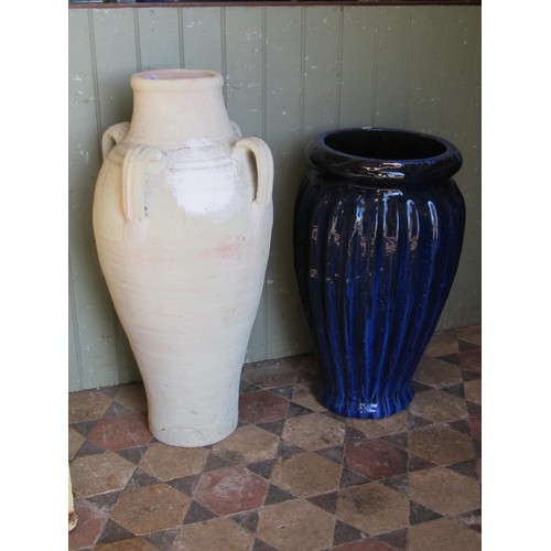 1044 - A Mediterranean terracotta jar with moulded loop handles, 83 cm high, together with a contemporary d... 