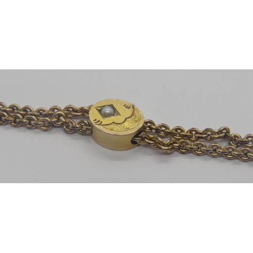 301 - Antique gilt metal long guard chain necklace with engraved pearl set slider, 66cm L approx