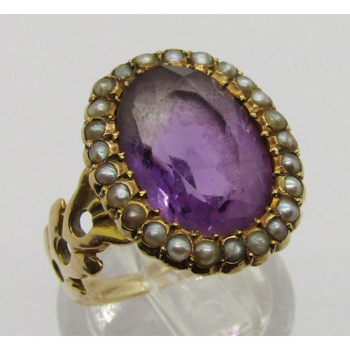 310 - Antique yellow metal amethyst and seed pearl oval cluster ring with pierced shoulders, size J, 4.8g