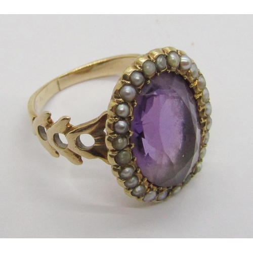 310 - Antique yellow metal amethyst and seed pearl oval cluster ring with pierced shoulders, size J, 4.8g