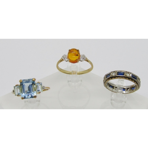 322 - Three 9ct gem set dress rings to include a cabochon amber and diamond three stone example, a blue sp... 