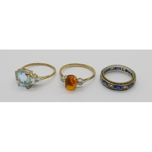 322 - Three 9ct gem set dress rings to include a cabochon amber and diamond three stone example, a blue sp... 