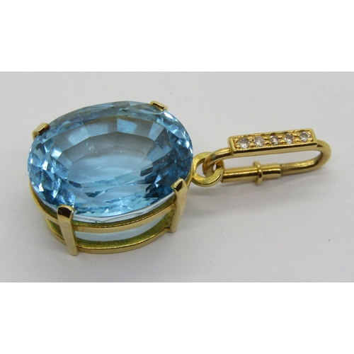 344 - Yellow metal claw set oval blue topaz pendant, the detachable diamond set bale with spring closure, ... 