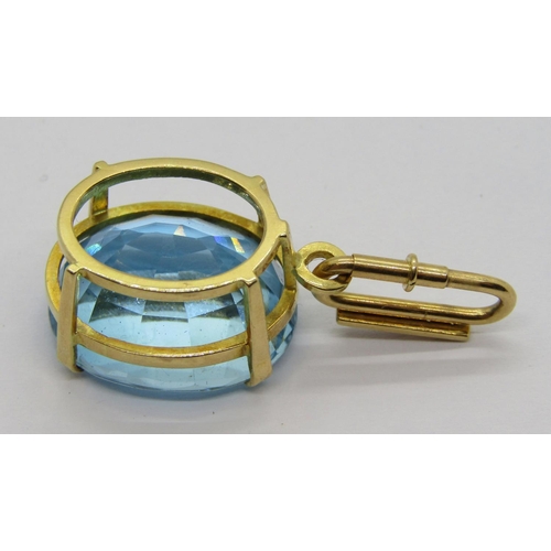 344 - Yellow metal claw set oval blue topaz pendant, the detachable diamond set bale with spring closure, ... 