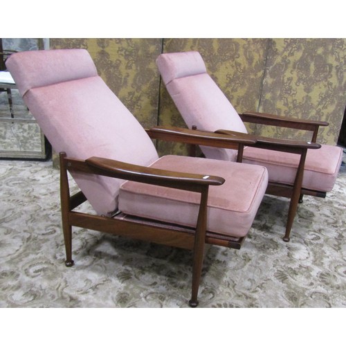 1111 - A pair of good quality mid 20th century teak framed lounge chairs with open shaped arms, raised on s... 