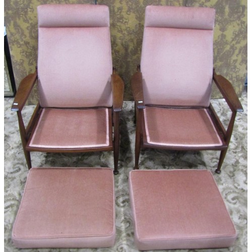 1111 - A pair of good quality mid 20th century teak framed lounge chairs with open shaped arms, raised on s... 