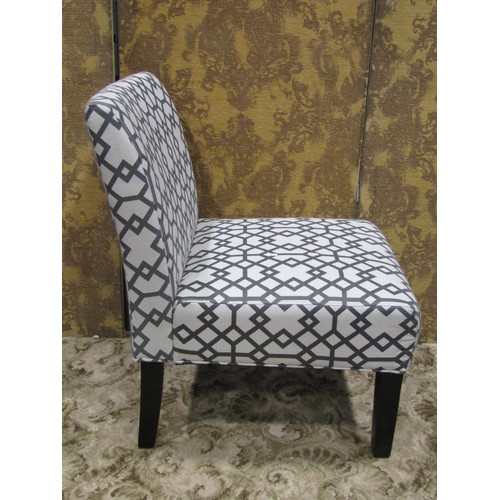 1113 - A contemporary single chair with geometric patterned upholstered seat and back raised on square tape... 