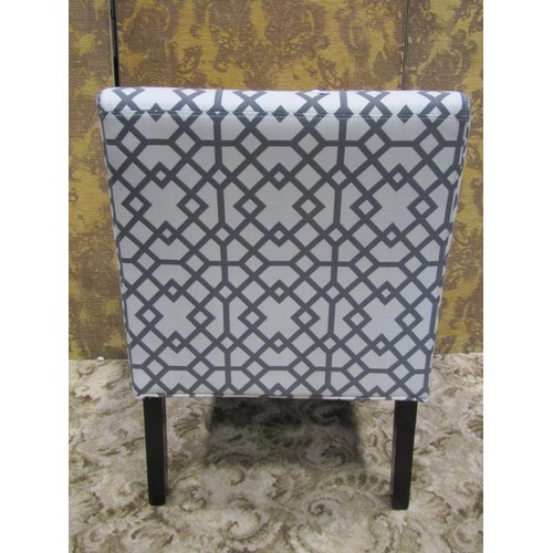 1113 - A contemporary single chair with geometric patterned upholstered seat and back raised on square tape... 