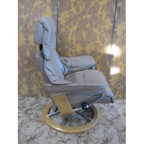 1117 - An Ekorness Stressless swivel and adjustable lounge chair and matching stool with soft leather uphol... 