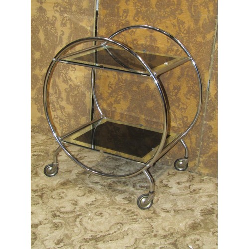 1120 - An Art Deco style tea trolley, the open tubular ring frame supporting two graduated mirror glass pan... 