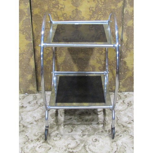 1120 - An Art Deco style tea trolley, the open tubular ring frame supporting two graduated mirror glass pan... 