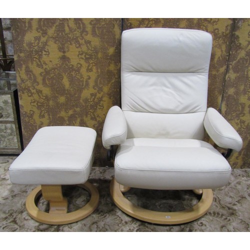 1122 - An Ekorness Stressless swivel and adjustable lounge chair and matching stool with stitched cream lea... 