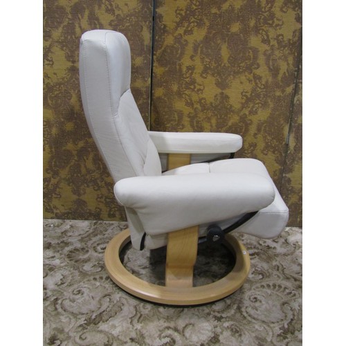 1122 - An Ekorness Stressless swivel and adjustable lounge chair and matching stool with stitched cream lea... 