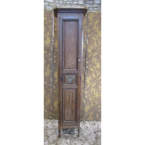 1130 - A tall narrow antique stained pine cupboard enclosed by a triple paneled door raised on turned suppo... 