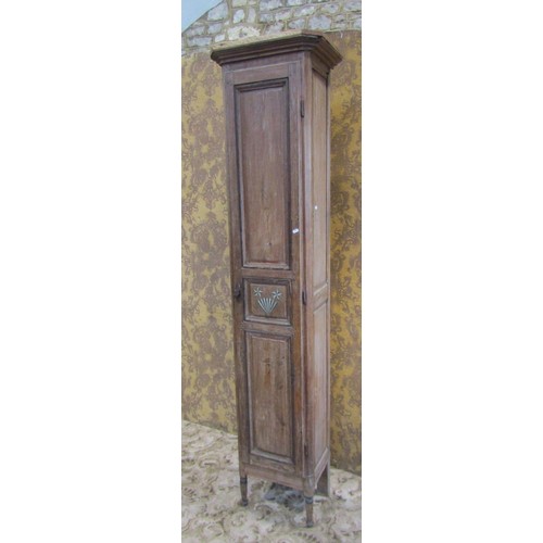 1130 - A tall narrow antique stained pine cupboard enclosed by a triple paneled door raised on turned suppo... 