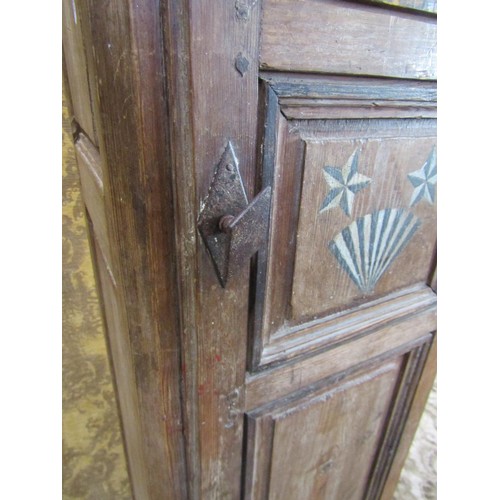 1130 - A tall narrow antique stained pine cupboard enclosed by a triple paneled door raised on turned suppo... 