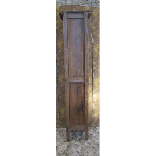 1130 - A tall narrow antique stained pine cupboard enclosed by a triple paneled door raised on turned suppo... 